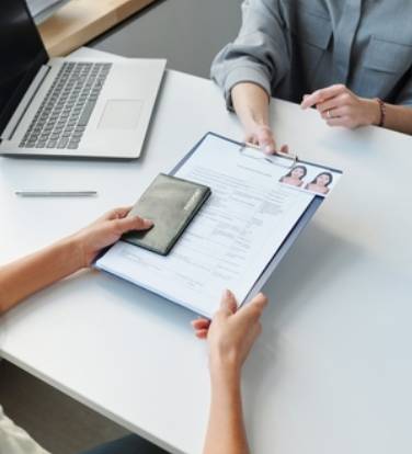 Woman Applying For Visa At Table